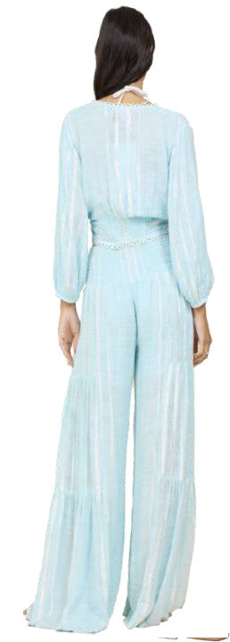 Woman wearing Surf Gypsy wide leg pant in crystal blue stripes back view